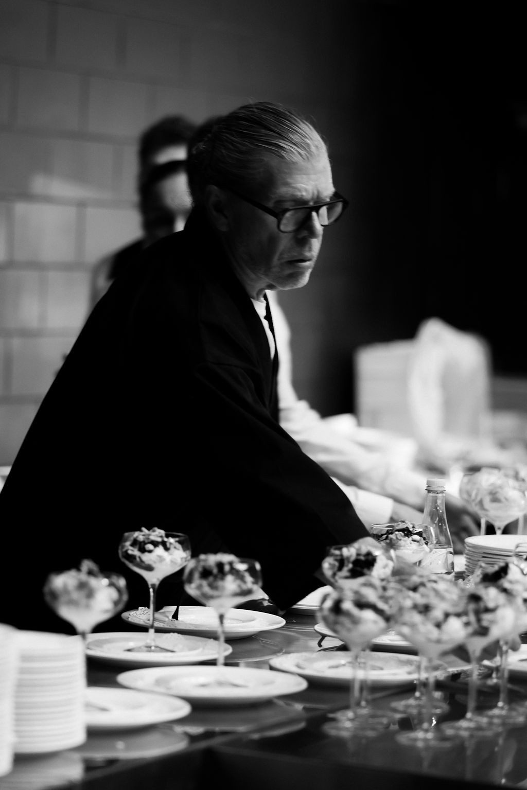 Black-and-white portrait of John Wilson overseeing a catering service